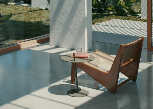 Covered concrete patio with a chair and table beside large windows